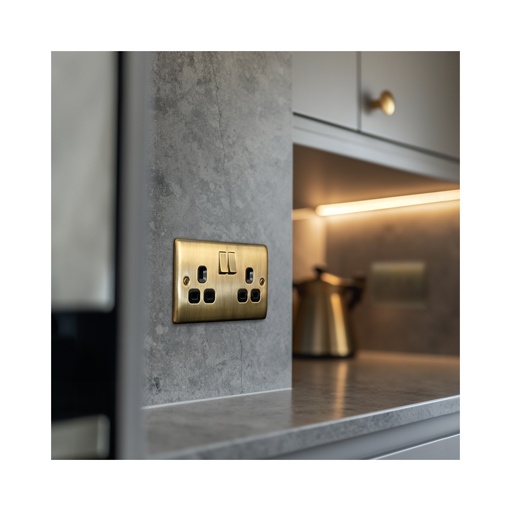 Antique brass double socket in a lifestyle photo showing a kitchen