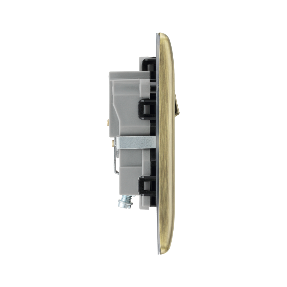 Light switch profile with brass-coloured plate on a white background