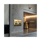 Antique brass double socket in a lifestyle photo showing a kitchen