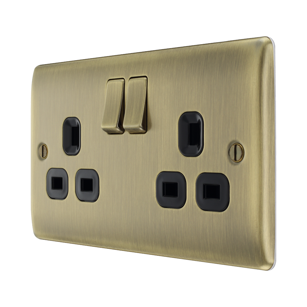 Antique brass double socket with black inserts on a white background angled view