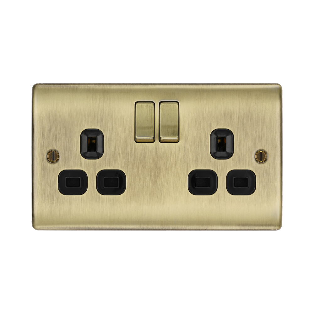 Antique brass double socket with black inserts on a white background