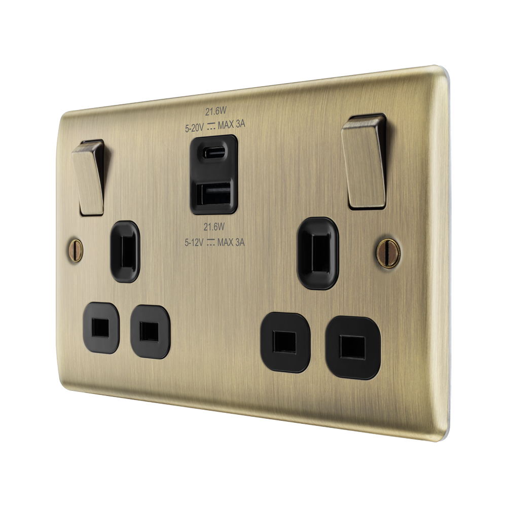 Brass electrical USB socket with black outlets on a white background