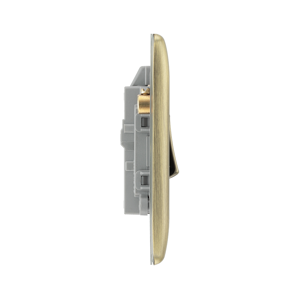 Light switch profile with brass front plate on a white background