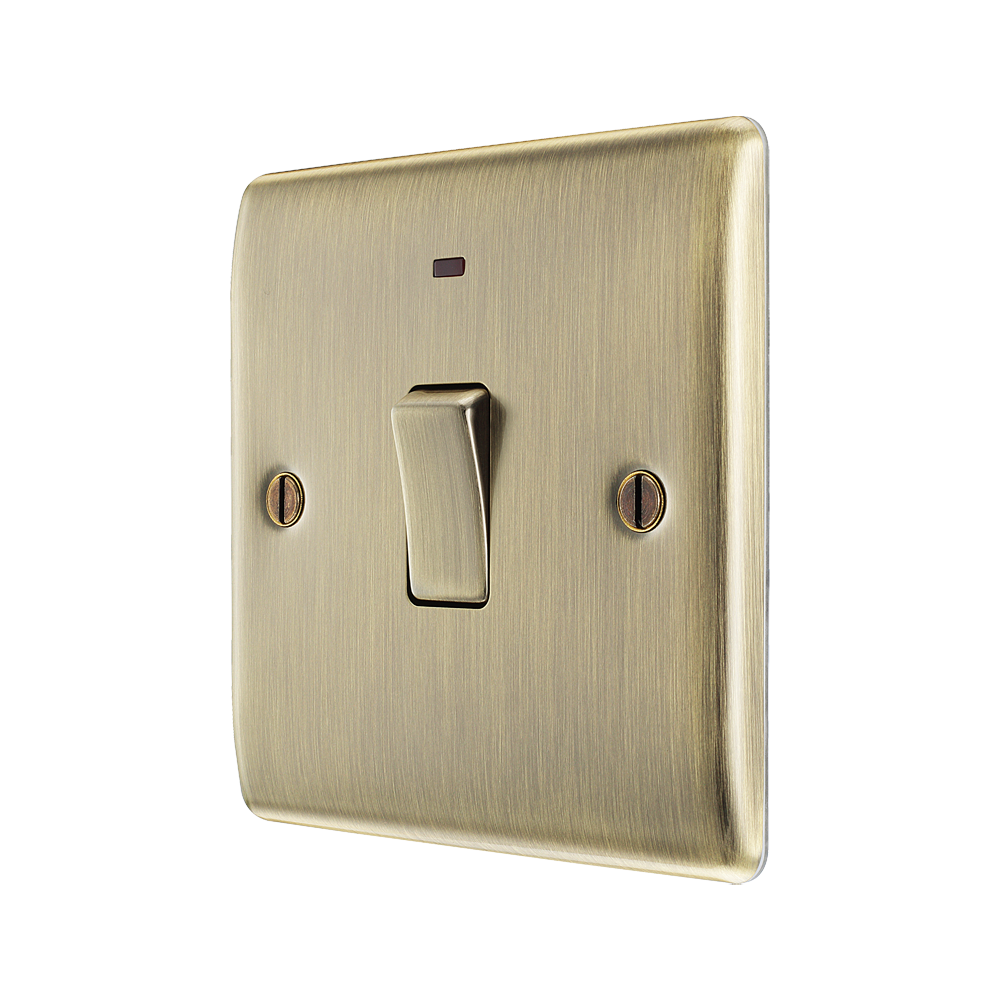 Brass light switch with a single rocker switch on a white background