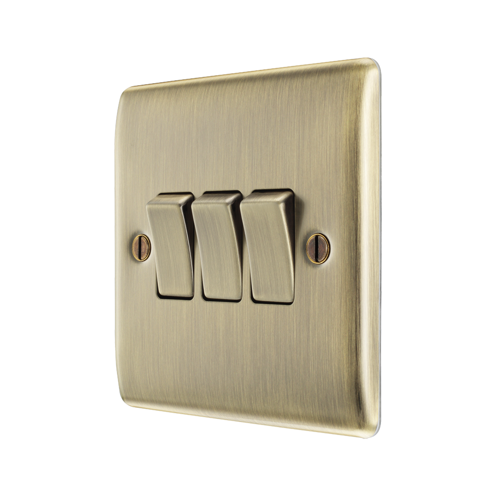 Brass light switch with three rocker positions on a white background
