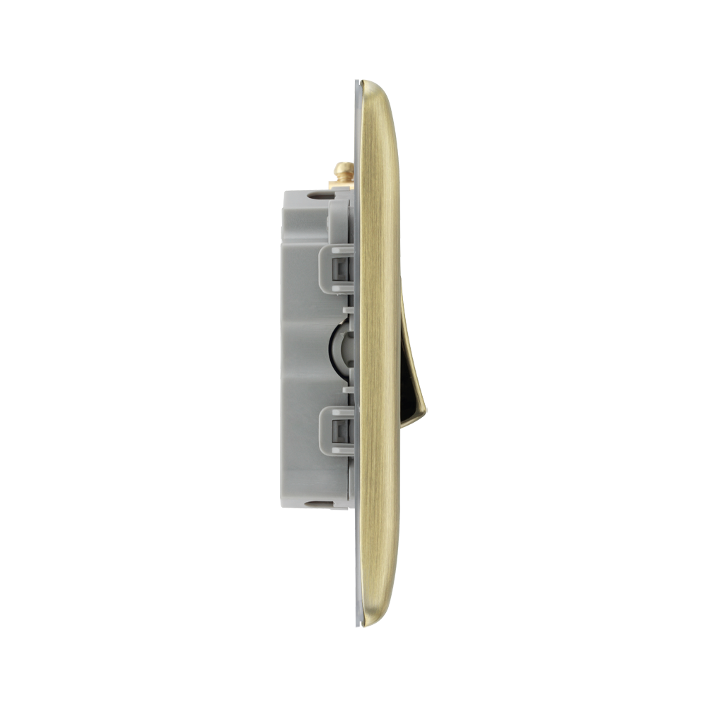 Light switch profile with brass front plate on a white background