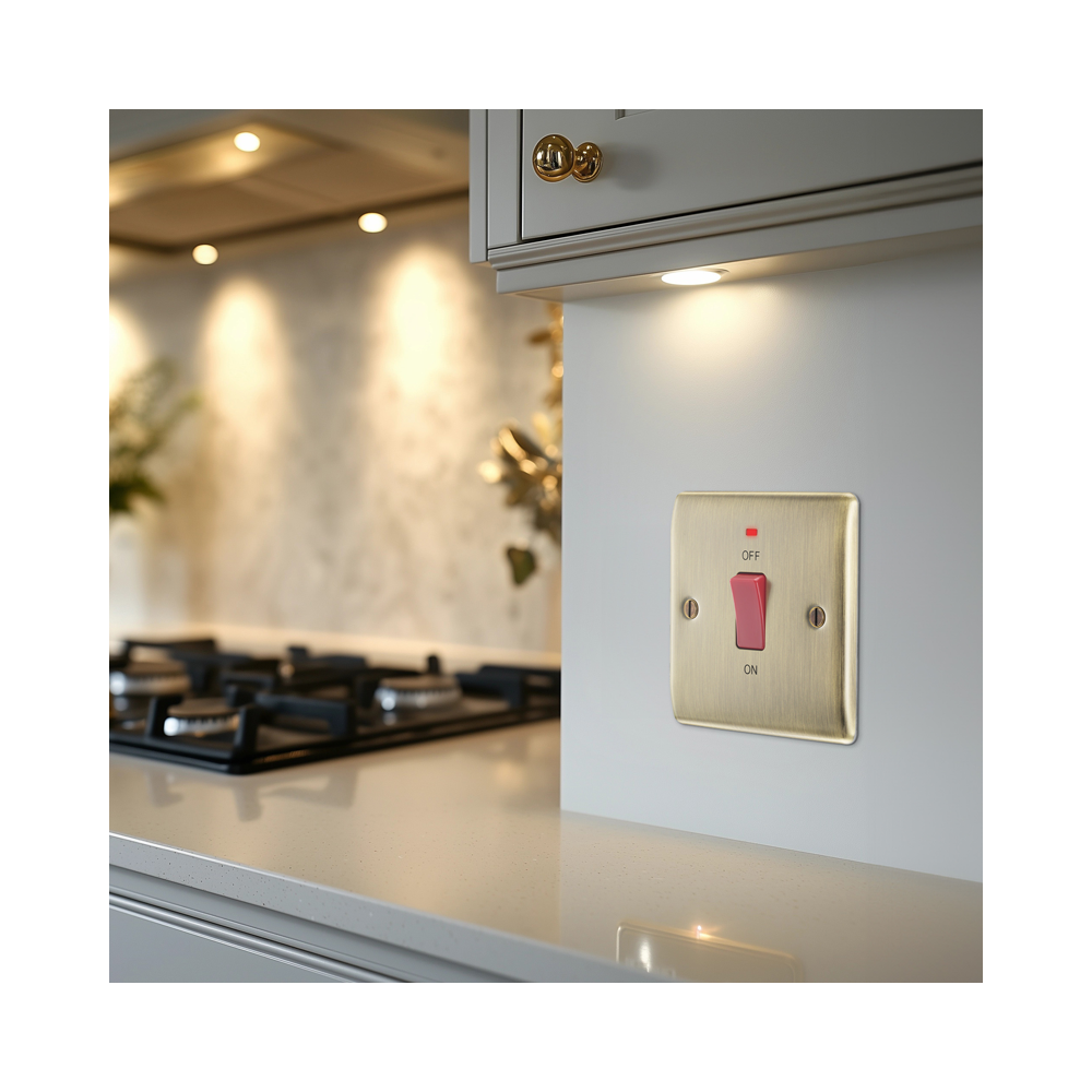 BG Nexus Metal Antique Brass Cooker Switch installed on an interior wall