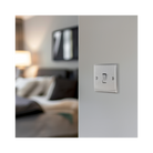 Metallic light switch on a white background bedroom setting