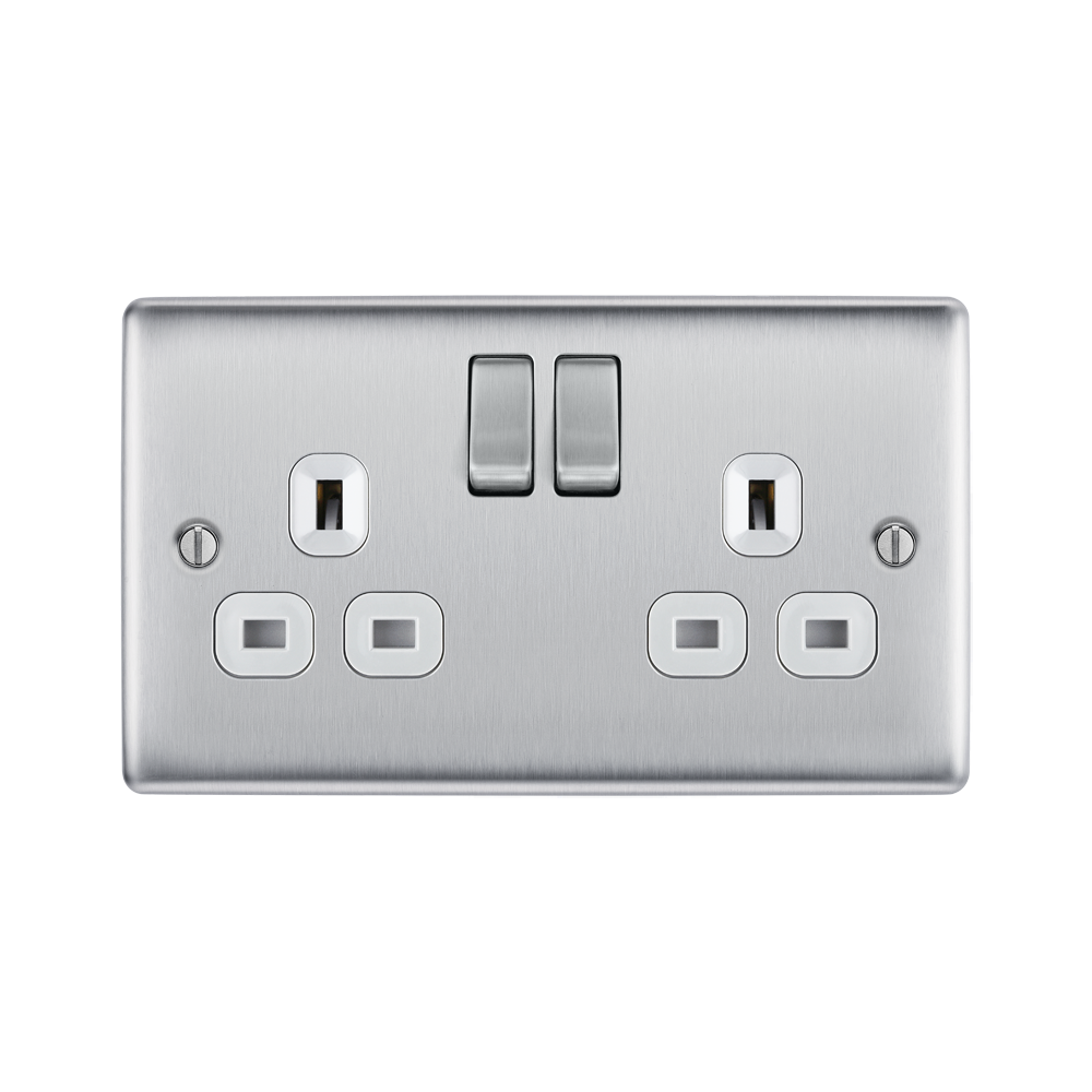 Metallic light switch with multiple sockets and switches on a white background