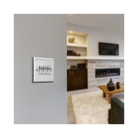 Metallic light switch panel with three toggle switches on a white background lounge setting