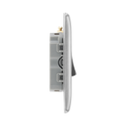 Metallic light switch panel with three toggle switches on a white background profile