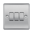 Metallic light switch panel with three toggle switches on a white background