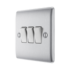 Metallic light switch panel with three toggle switches on a white background side